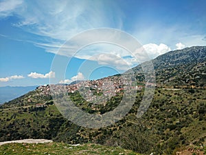 Arachova town on hillside of mount Parnassos mountain in spring , Greece