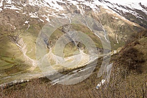 Aragvi River valley and snowy slopes of Caucasian ridge, Georgia