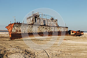 Aral sea disaster. Abandoned rusty fishing boat at the desert on the place of former Aral sea