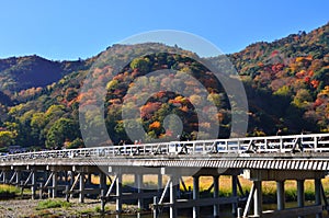 Arashiyama and wooden bridge in color of autumn, Kyoto Japan.