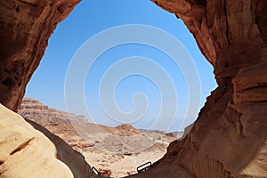 Arava desert landscape through an erosive stone window in a rock, Israel photo