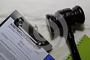 Arbitration Agreement Document form and Black Judges gavel on office desk. Law concept