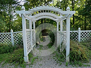 Arbor leading to a shady tree filled park