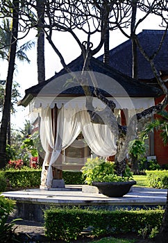 Arbor with white curtains for relaxation or meditation. Bali Island, Indonesia