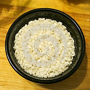 Arborio rice in a black ramekin