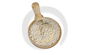 Arborio risotto short grain rice in wooden bowl and scoop isolated on white background. nutrition. bio. natural food ingredient