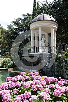 Arbour with waterfall in garden