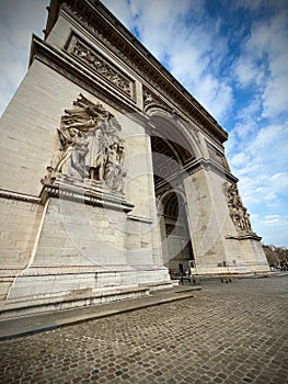 The Arc de Triomphe in Paris with Dramatic Sculptural Relief and a Bright Sky