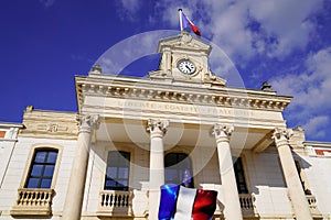 Arcachon town hall in blue sky in France with candy vintage french flag