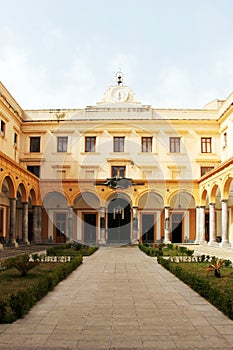 Arcaded courtyard, college, with clock tower photo