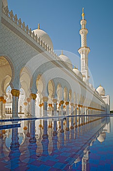 Arcades reflected in the pool in the Sheikh Zayed Grand Mosque.Abu Dhabi.UAE