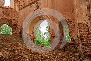 An arch in an abandoned old church made of red brick. View from the inside. Russia, Smolensk region, 1753