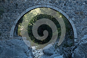 Arch of ancient Roman bridge over a mountain river in the Kesme Bogazi canyon, Turkey