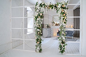 Arch with artificial flowers in the room