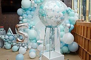 Arch of blue balloons for boy happy birthday party. Number 5 for five years old child. Festive decorative elements, photo zone