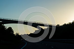 Arch bridge above motorway.