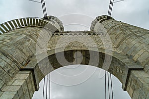 arch of bridge against cloudy sky