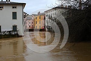 Arch of a bridge submerged by the swollen Retrone River in Vicenza in Italy during a flood caused by climate change