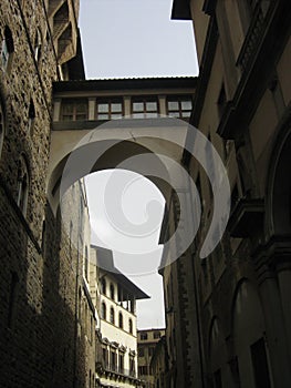 An arch and bridge between two buildings