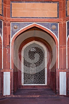 Arch with carved marble window. Mughal style