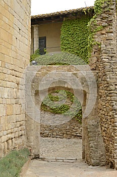 Arch at cobbled street in Girona village