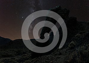 An arch of cold lava in the caldera of Tenerife with the Milky Way in the sky.