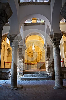 Arch and columns and a cross with a Christ inside a Muslim mosque in Toledo photo