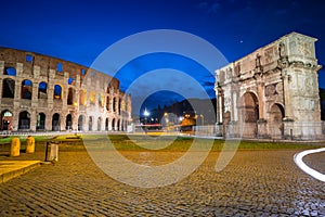 Arch of Constantine and the Colosseum illuminated at night in Rome, Italy