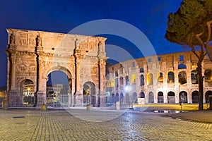 Arch of Constantine and the Colosseum illuminated at night in Rome, Italy