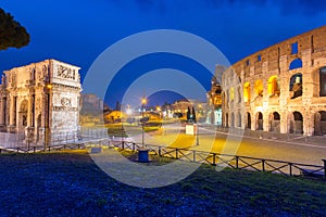 Arch of Constantine and the Colosseum illuminated at night in Rome, Italy