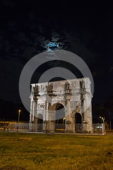 arch of constantine of the roman forum viewed at night near the colosseum in rome, Italy