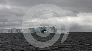 Arch of Darwin unique glacier iceberg in ocean of Antarctica.