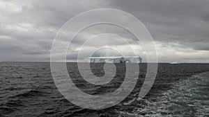 Arch of Darwin unique glacier iceberg in ocean of Antarctica.