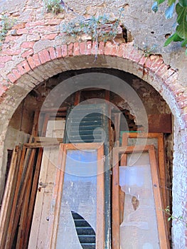 Arch door, abandoned medieval house, Toiano, Pisa, Italy.