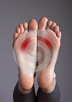 Arch pain, inflammation, overuse, plantar fascia injury. Foot with red points