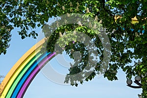 Arch, painted in the colors of the rainbow, and chestnuts in Kyiv, Ukraine.