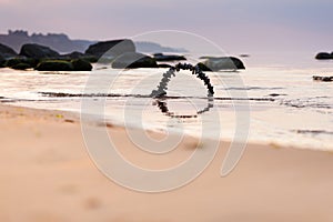 Arch of pebbles on the beach