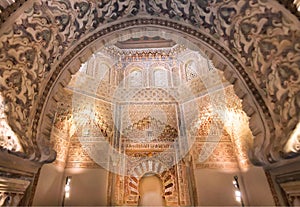 Arch with relief in historical style, ceiling of 14th century Madraza de Granada, Spain