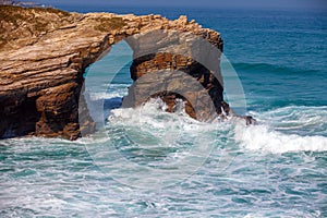 Arch in the rock. Beach Playa de Augas Santas photo