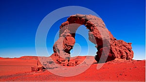 Arch Rock formation aka Arch of Africa or Arch of Algeria with moon at Tamezguida in Tassili nAjjer in Algeria