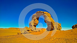 Arch Rock formation aka Arch of Africa or Arch of Algeria with moon at Tamezguida in Tassili nAjjer national park in Algeria