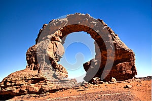 Arch Rock formation aka Arch of Africa or Arch of Algeria with moon at Tamezguida in Tassili nAjjer national park in