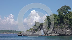 Arch in Sea Cliff and Tropical Clouds