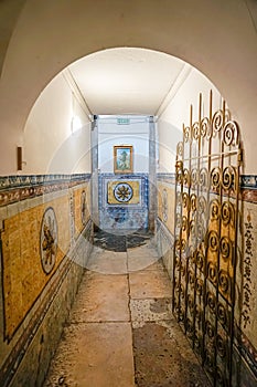 Arch-shaped pedestrian access corridor inside the Santo AntÃ³nio church in Lisbon photo