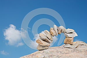 Arch of stones with blue sky background and clouds