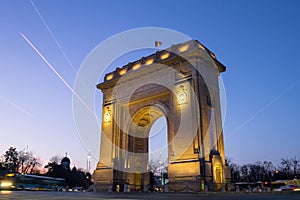 Arch of Triumph Arcul de Triumf in Bucharest, Romania, at sunset, with blue and pink skies. Low angle and long exposure shot. photo