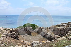 The archaeological area of Tharros and a yacht in Sardinia Italy