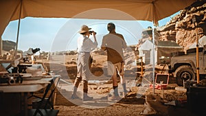 Archaeological Digging Site: Two Great Archeologists Work on Excavation Site, Inspect Newly