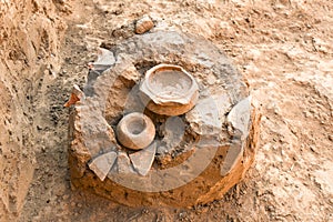 Archaeological excavation, fragments of amphorae lie on ground, ancient finds