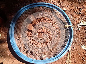 Archaeological excavation: sieve with dirt.